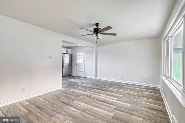 a kitchen with a refrigerator stove and wooden floors