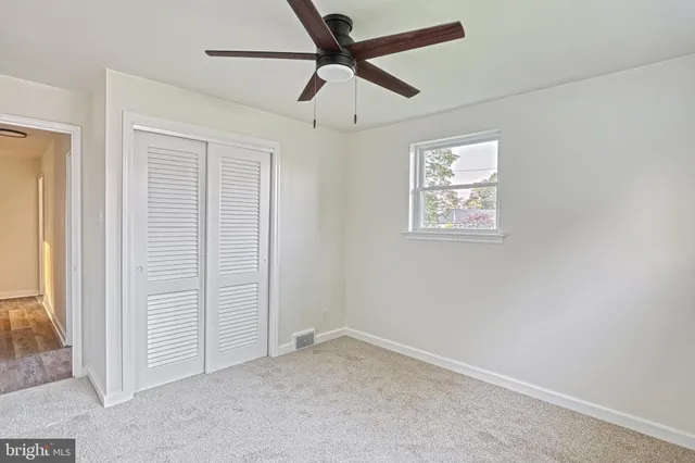 a view of an empty room with stairs