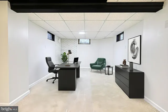 a aerial view of a house with a yard table and chairs