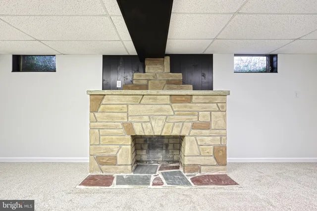 a view of a house with brick walls and a yard with plants
