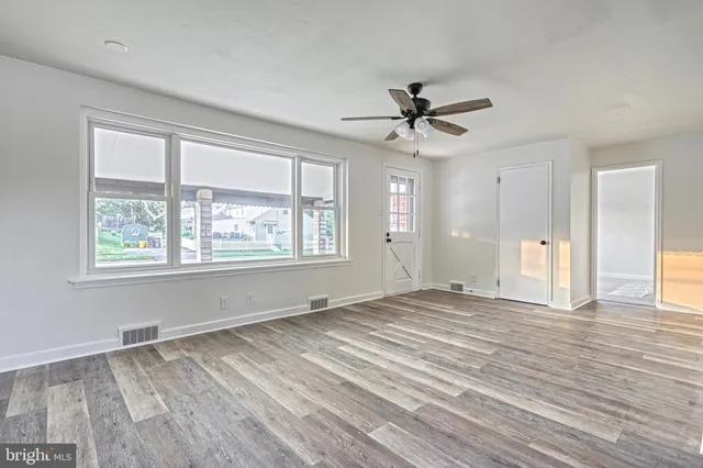 wooden floor in an empty room with a window