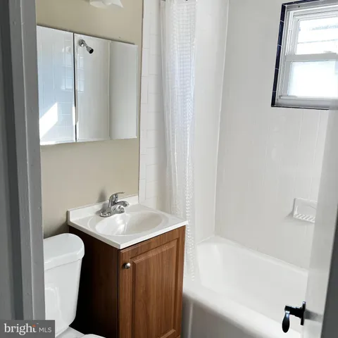 a bathroom with a sink a mirror and a bathtub