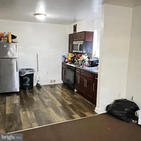 a kitchen with stainless steel appliances a stove a refrigerator and a sink