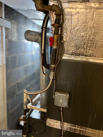 a room with water heater and wooden floor