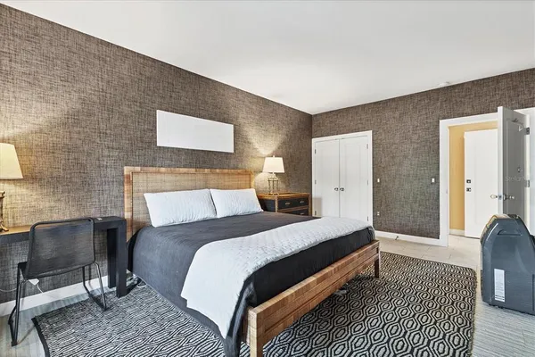 a bedroom with two beds and painting on the wall