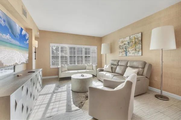 a living room with furniture and a lamp