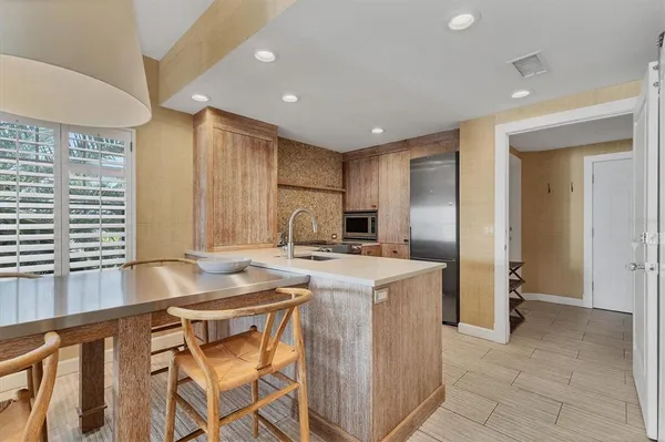 a kitchen with a refrigerator sink and cabinets