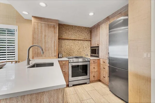 a kitchen with a sink stove and cabinets
