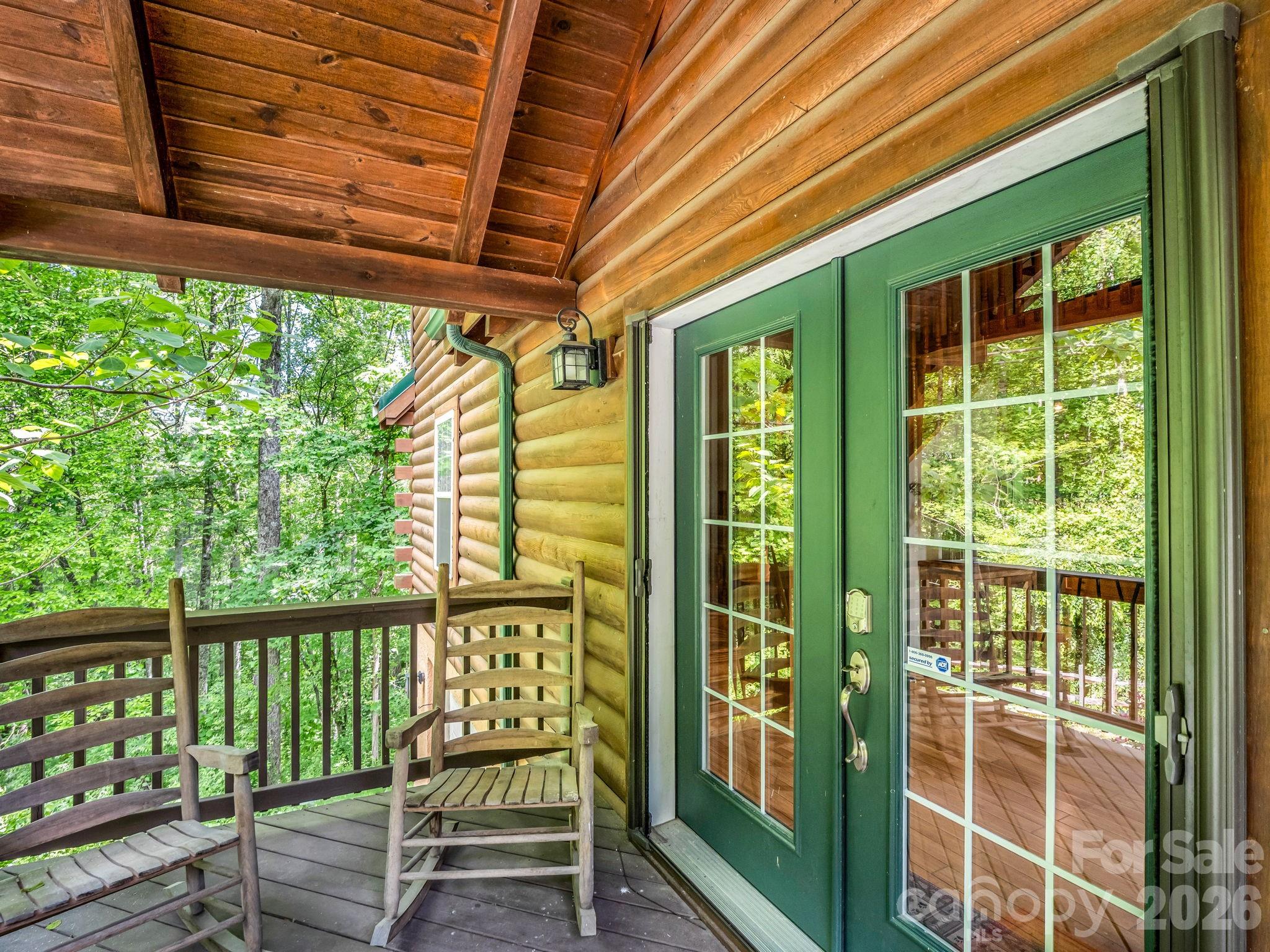 165 Dream Road Hendersonville, NC 28792 - Photo 7 of 46 a porch area with a table and chairs