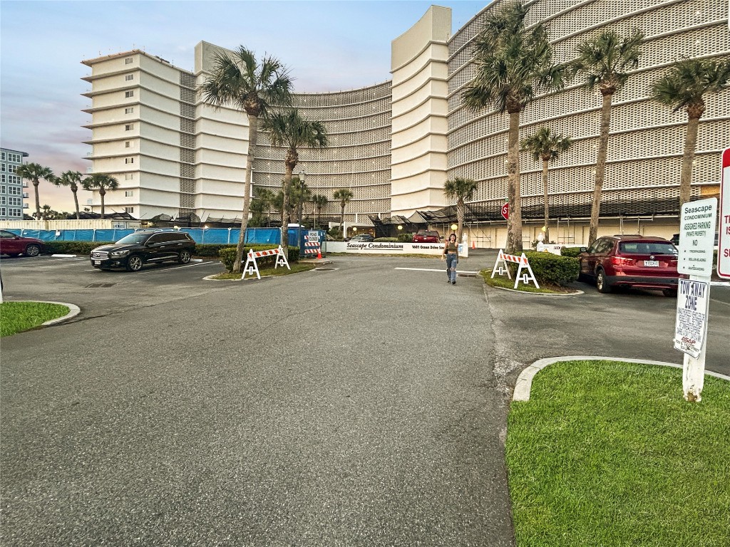 a view of a cars park in front of a building