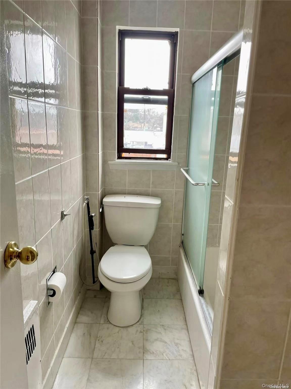7 Bond Street, Unit 3J Great Neck, NY 11021 - Photo 8 of 10 a white toilet sitting next to a bathroom sink