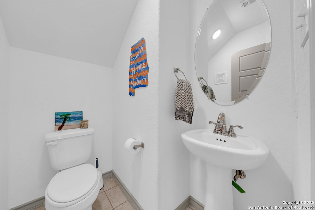 2045 Silver Oaks, Unit 18B San Antonio, TX 78213 - Photo 17 of 20 a bathroom with a toilet sink and mirror