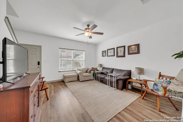 a living room with furniture and wooden floor