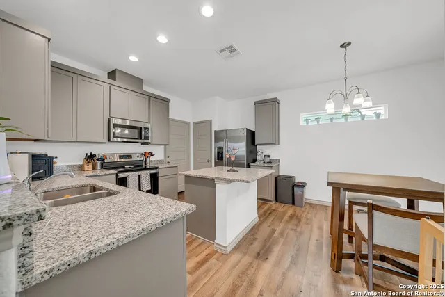 a kitchen with sink cabinets and stainless steel appliances