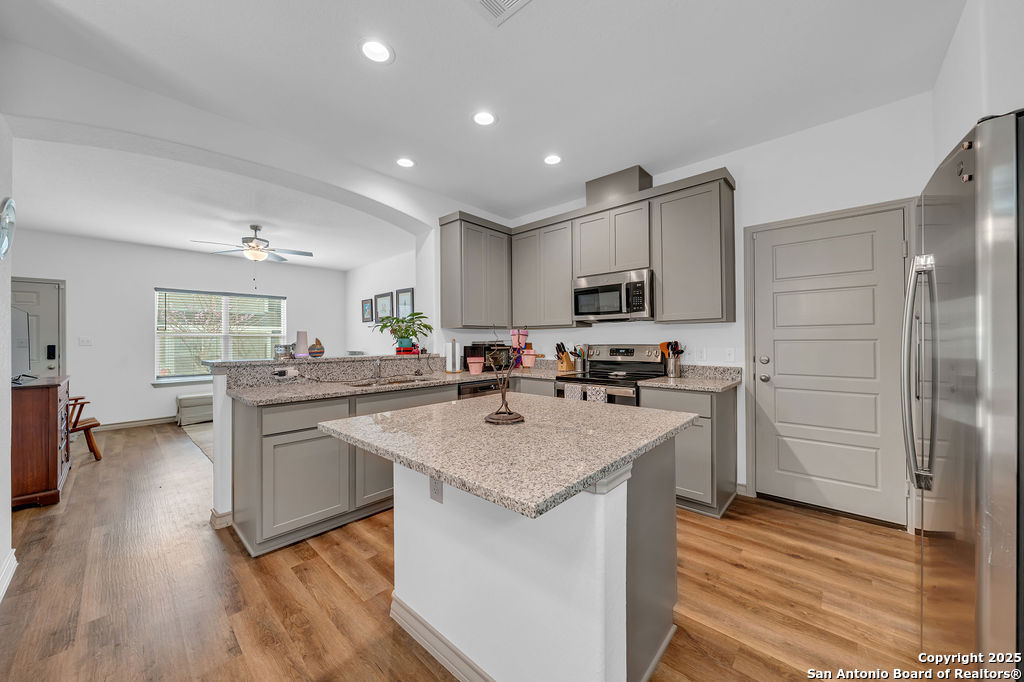 2045 Silver Oaks, Unit 18B San Antonio, TX 78213 - Photo 7 of 20 a kitchen with stainless steel appliances granite countertop a sink stove and refrigerator