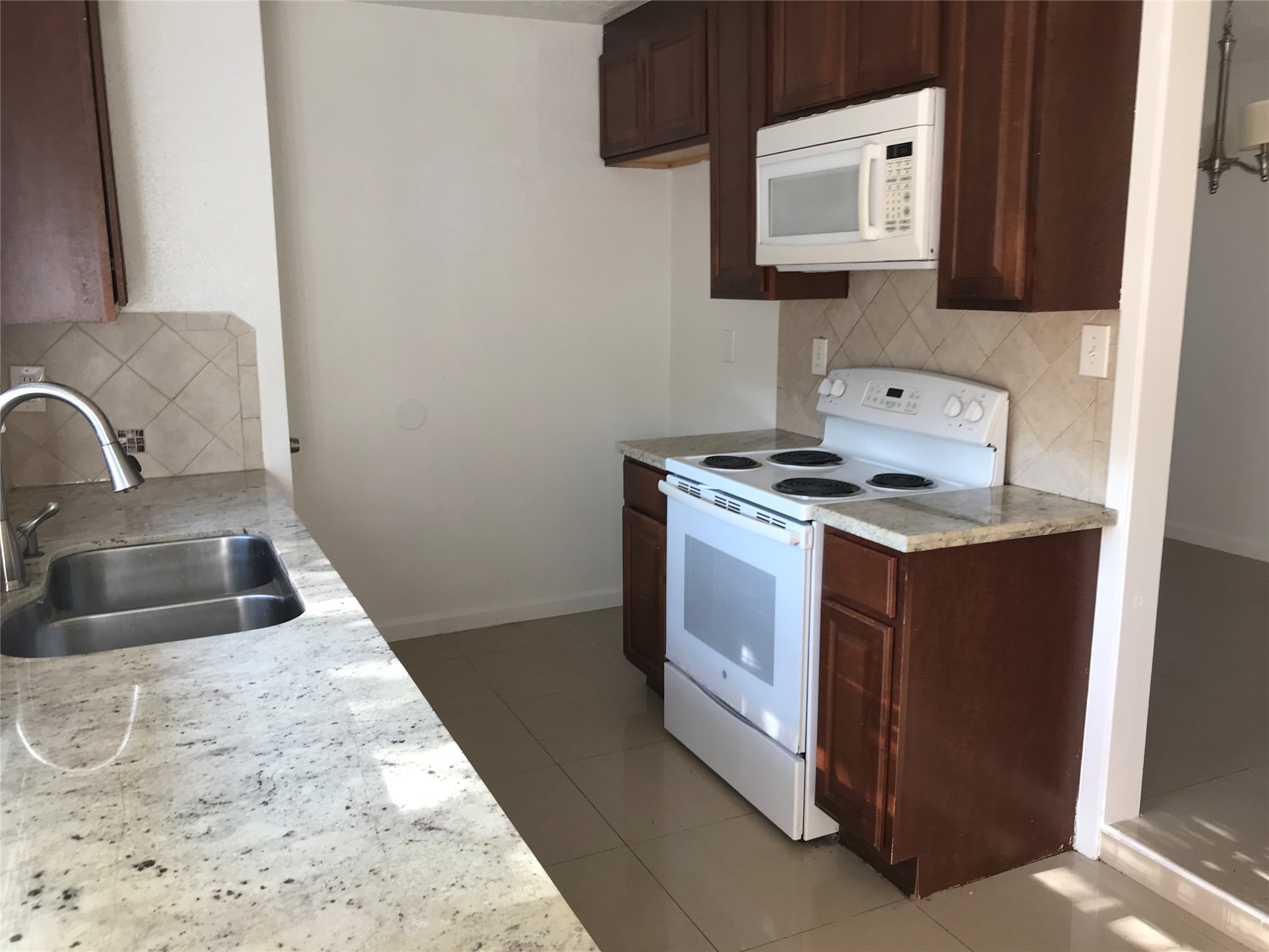 727 Doncrest Street Channelview, TX 77530 - Photo 13 of 40 a kitchen with stainless steel appliances granite countertop a sink and a stove top oven