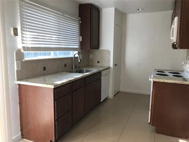 a kitchen with a sink and a window