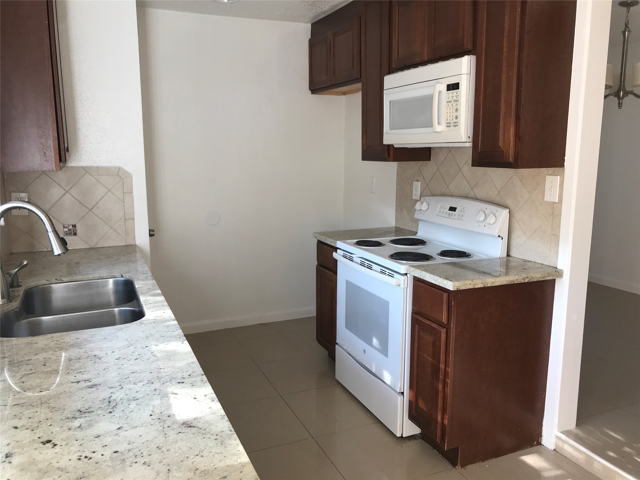 727 Doncrest Street Channelview, TX 77530 - Photo 15 of 40 a kitchen with a sink stove and microwave