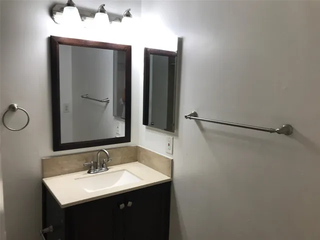 an empty room with a chandelier fan