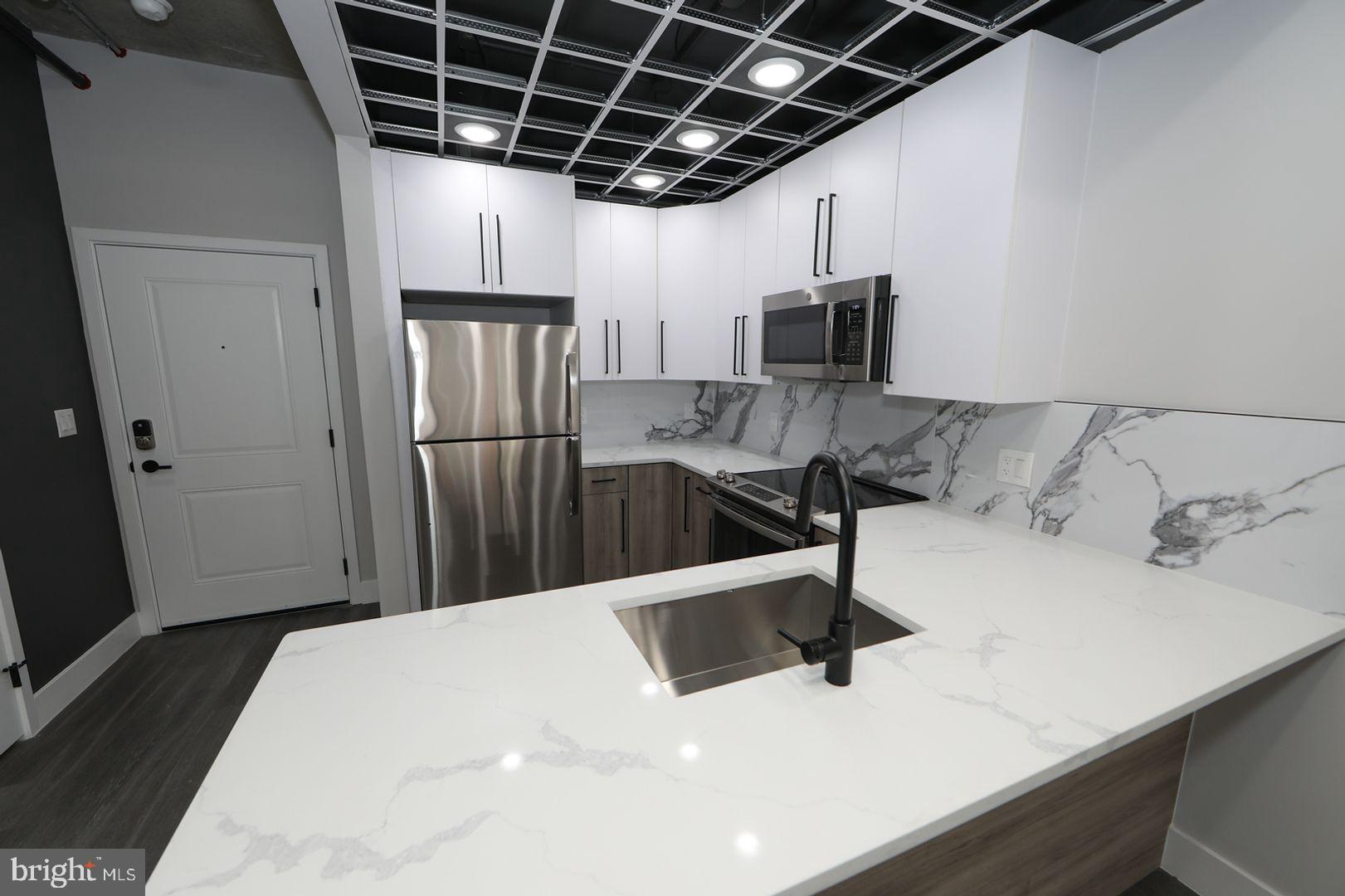 a kitchen with a sink and refrigerator