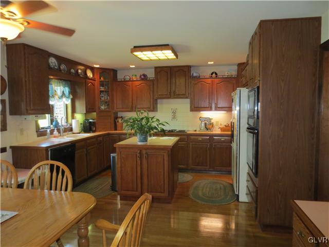 851 Bangor Road Nazareth, PA 18064 - Photo 15 of 49 a kitchen with granite countertop a refrigerator a stove a sink a dining table and chairs