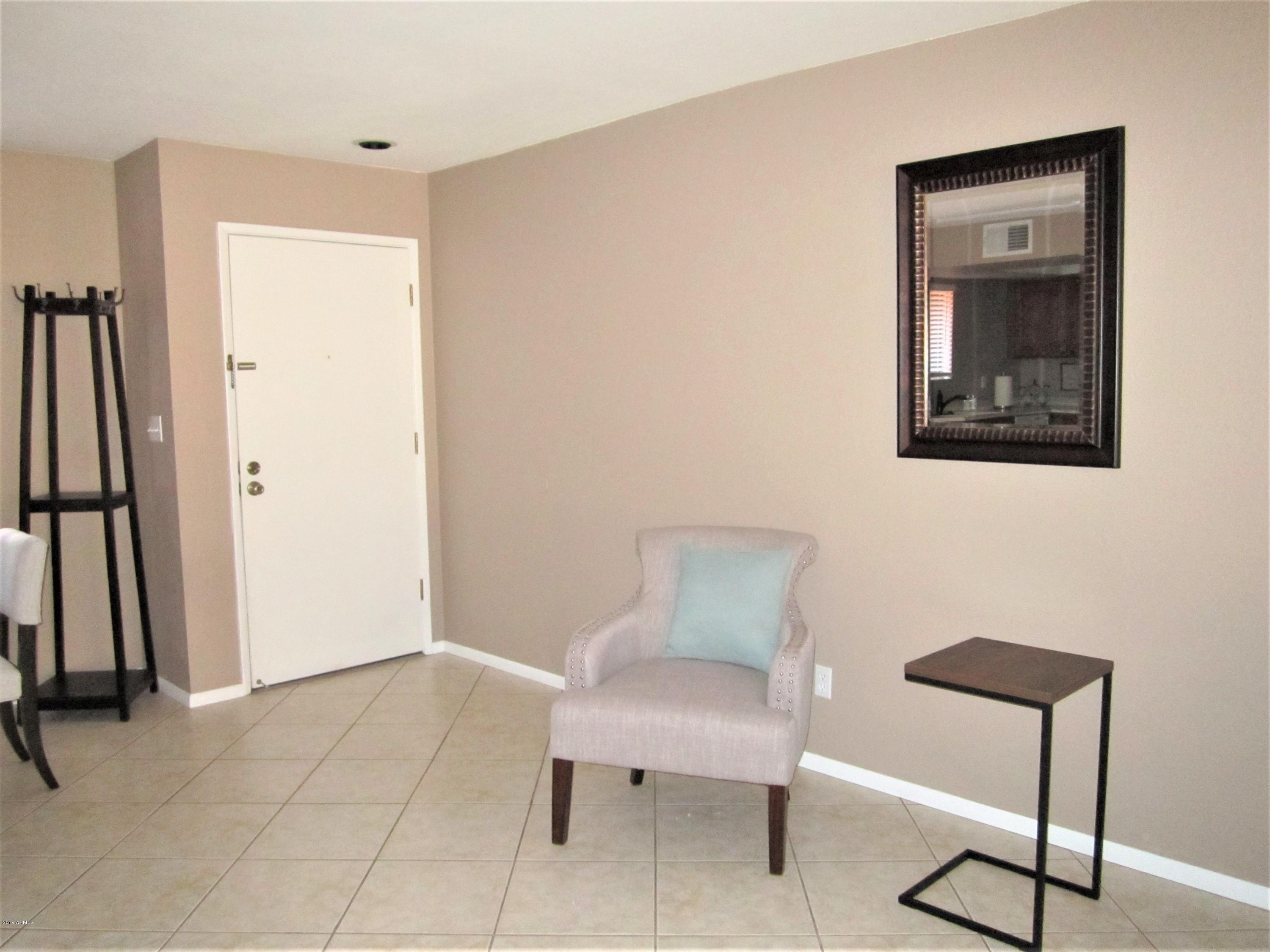 4303 East Cactus Road, Unit 116 Phoenix, AZ 85032 - Photo 8 of 35 a view of a room with furniture and wooden floor
