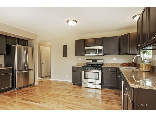 115 Moonlight Road Matteson, IL 60443 - Photo 4 of 10 a kitchen with stainless steel appliances granite countertop a refrigerator a stove top oven a sink and dishwasher