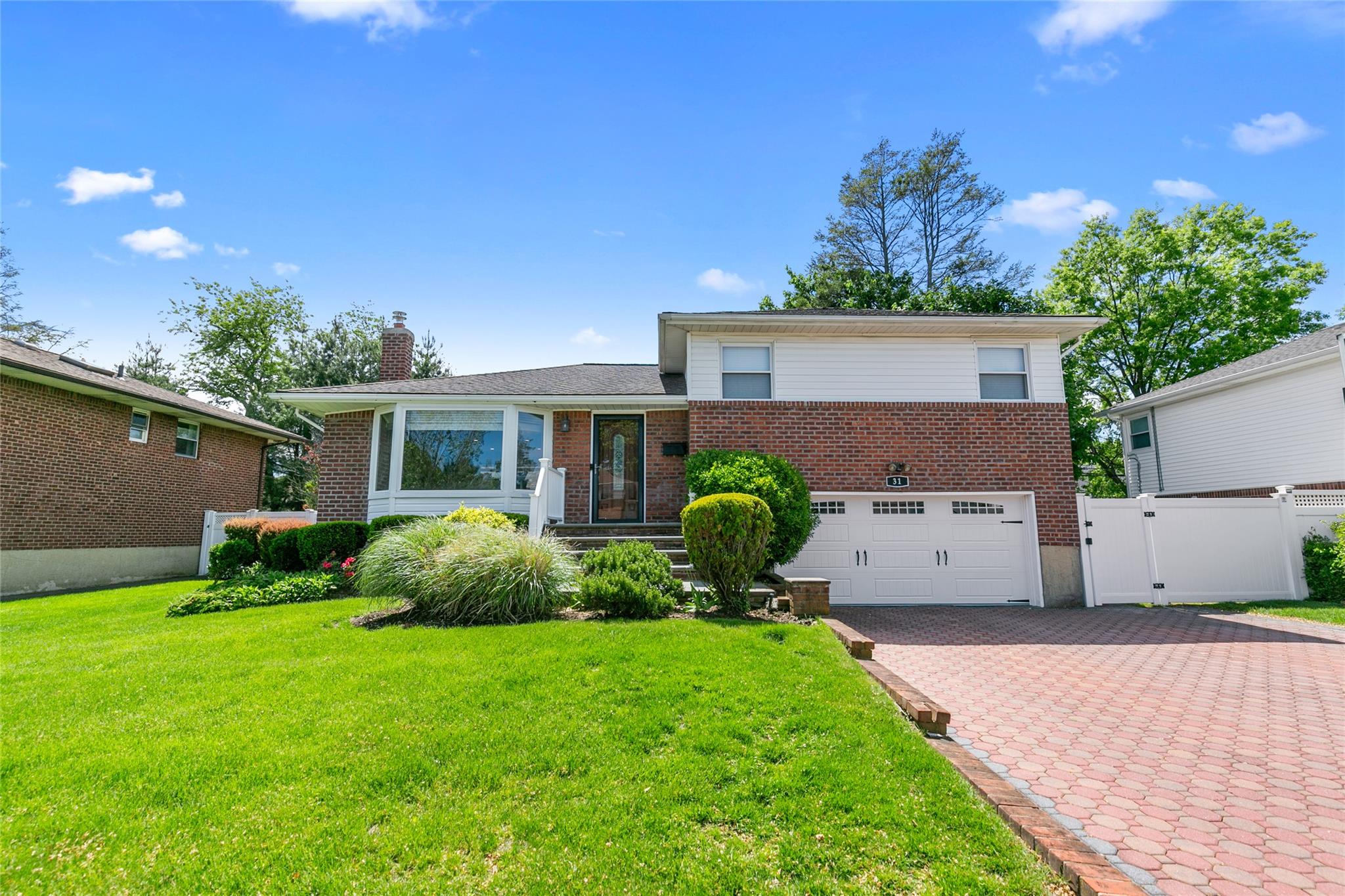 31 Roxton Road Plainview, NY 11803 - Photo 1 of 1 a front view of a house with garden