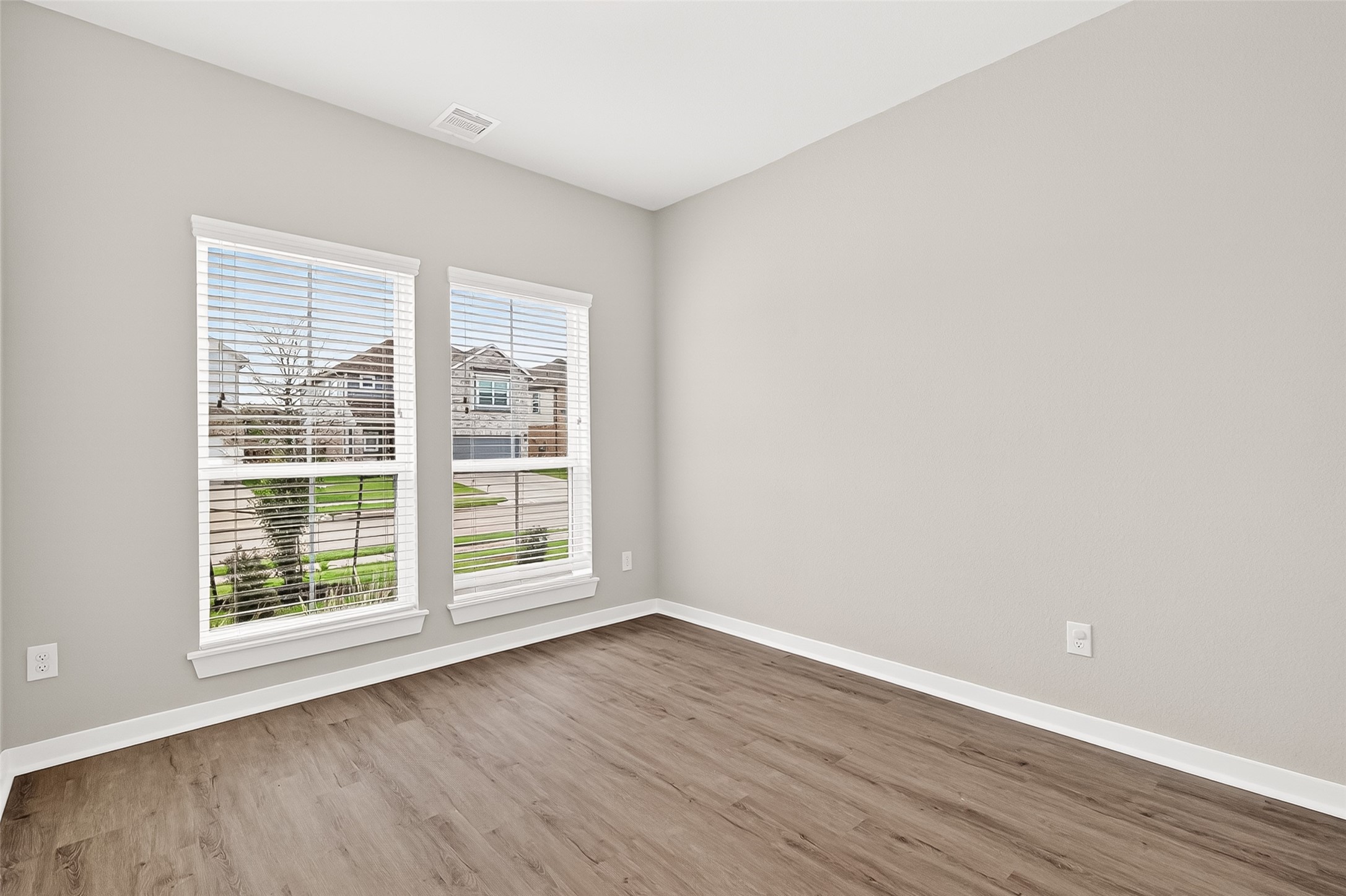 2142 Reed Cave Lane Spring, TX 77386 - Photo 5 of 50 a view of an empty room with wooden floor and a window