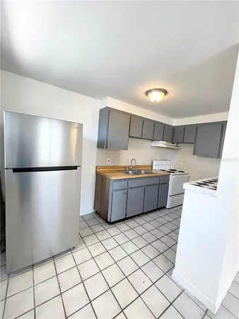 a kitchen with stainless steel appliances a refrigerator and a sink