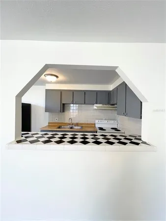 a white stove top oven sitting inside of a kitchen