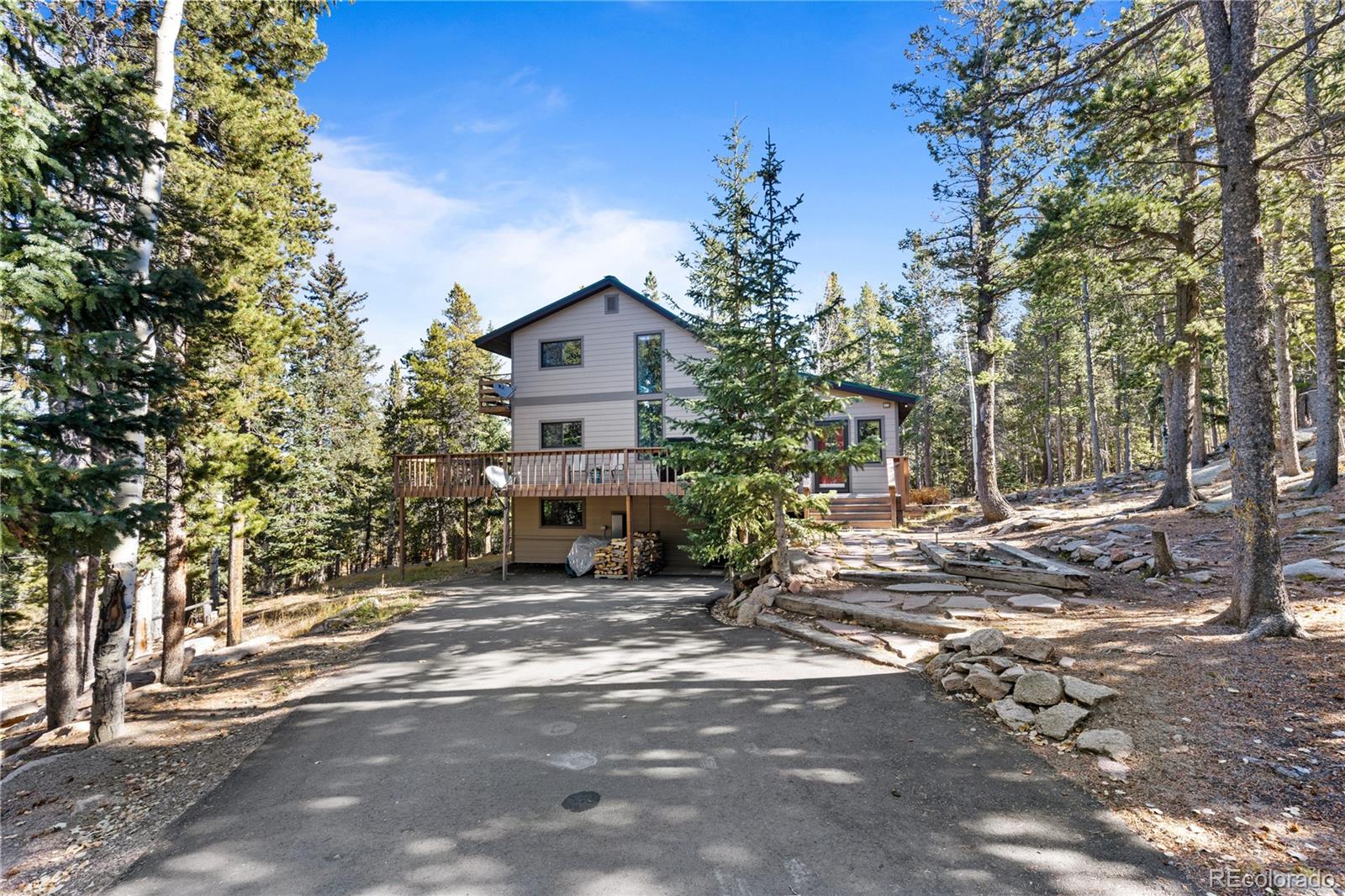 10684 Beas Drive Conifer, CO 80433 - Photo 1 of 38 a view of a house with a tree in front