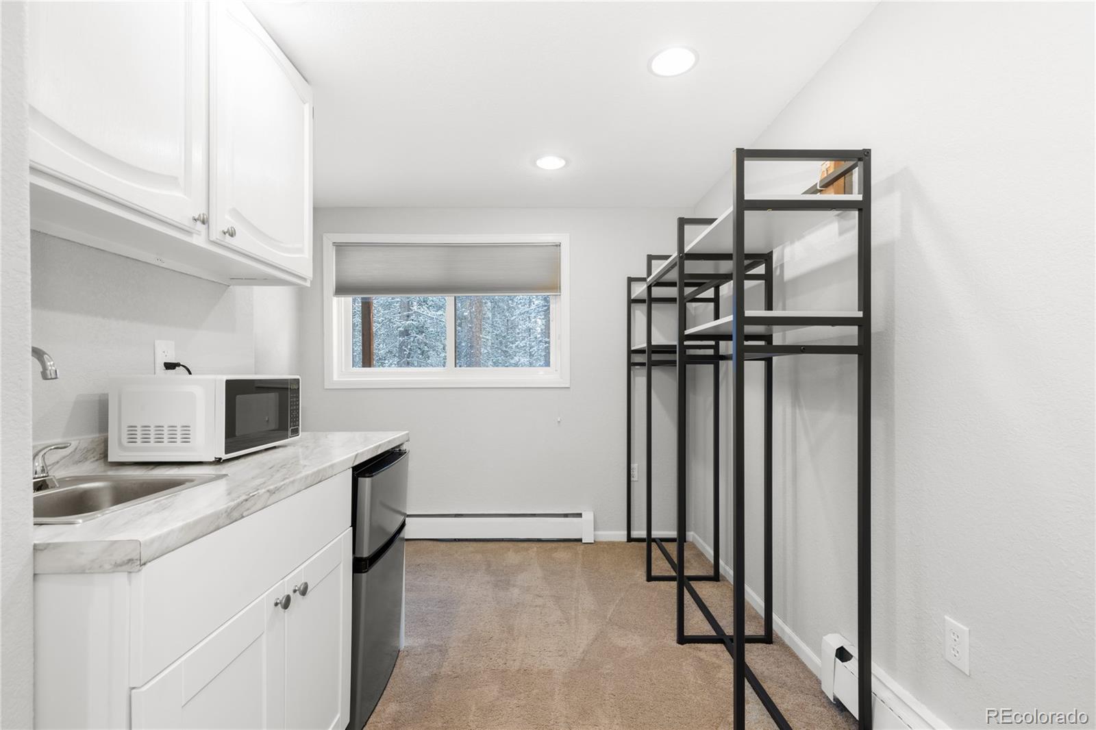 10684 Beas Drive Conifer, CO 80433 - Photo 28 of 38 a kitchen with refrigerator and window