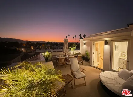 a living room with furniture and a lamp