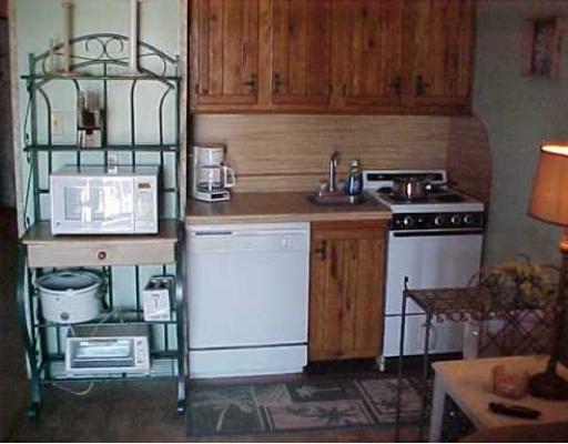 3938 Surfside, Unit 2223 2223 Corpus Christi, TX 78402 - Photo 2 of 9 a kitchen with a stove and a cabinet