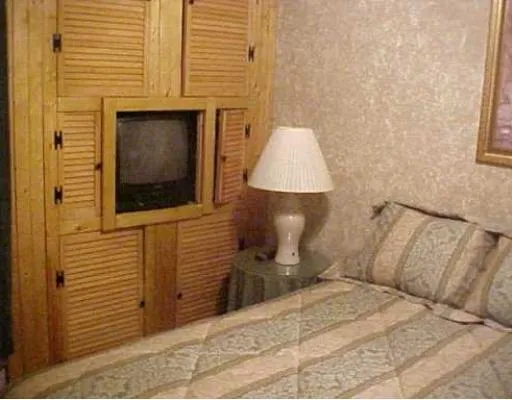 a bed room with a bed and a night stand