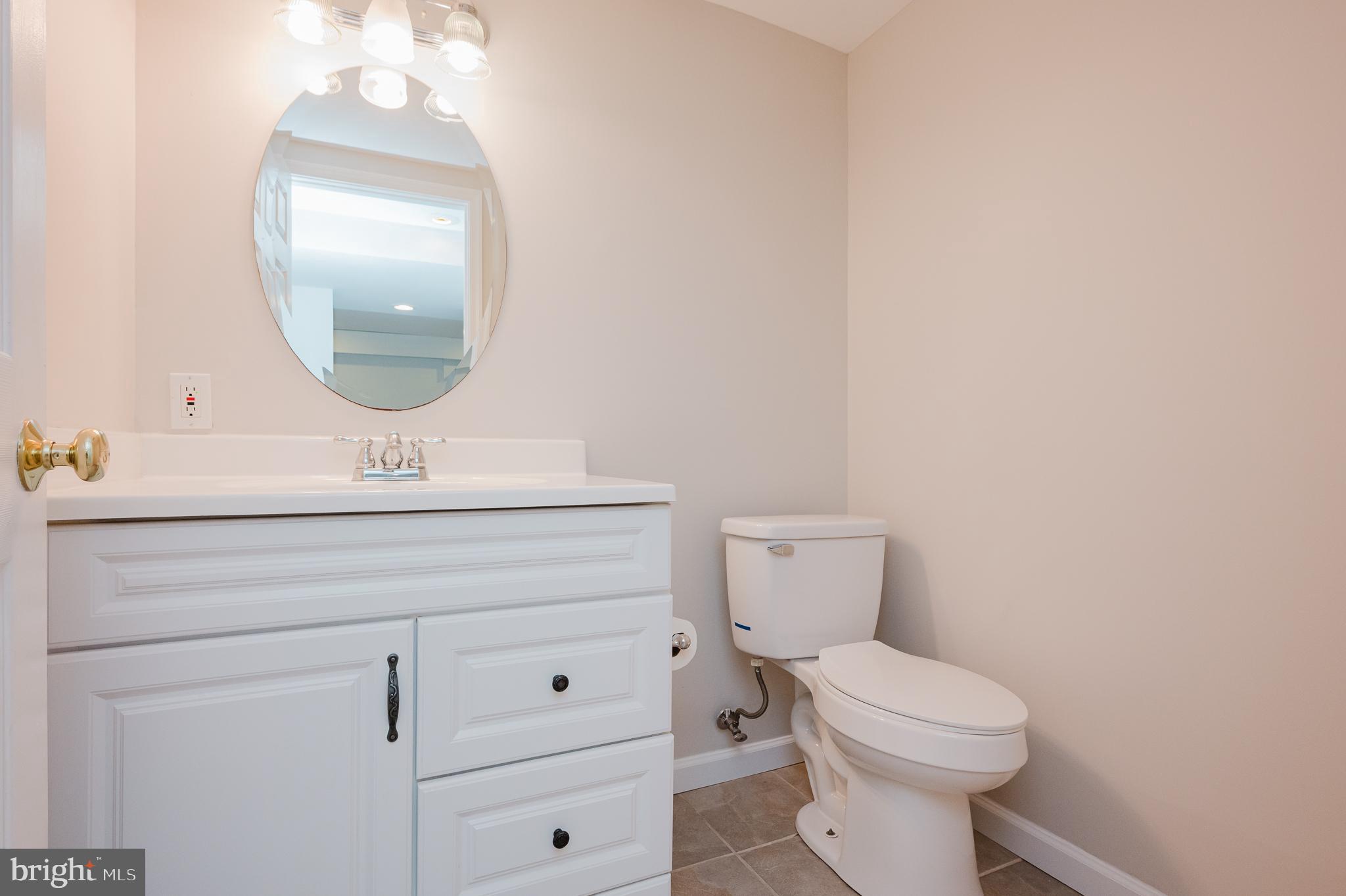 4 Old Spring Court Cockeysville, MD 21030 - Photo 53 of 53 a bathroom with a toilet a sink and mirror