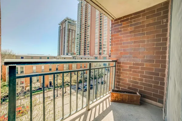 a view of a balcony and car parked