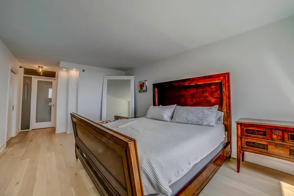 a bedroom with a bed and a book shelf