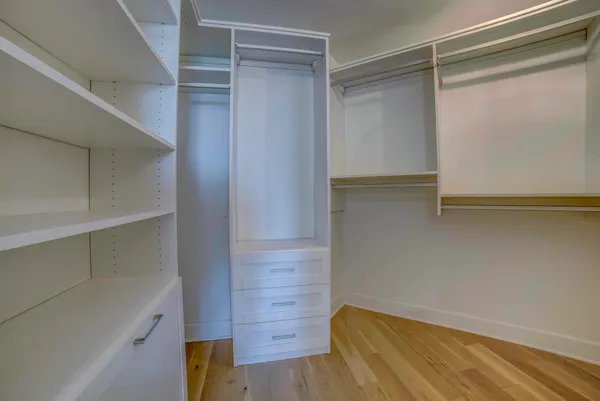 a view of walk in closet with empty racks