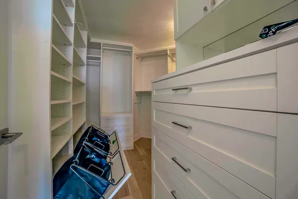 a view of walk in closet with empty racks