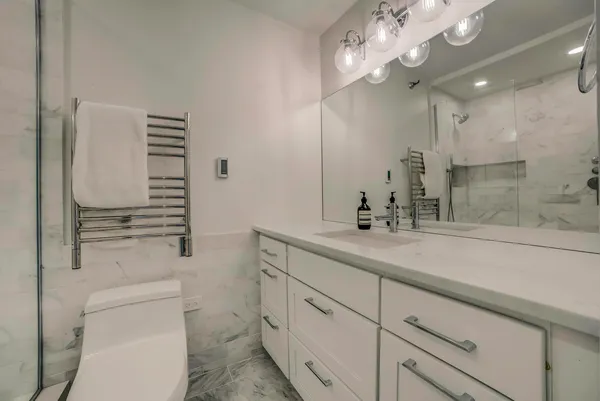 a bathroom with a sink a toilet and a mirror