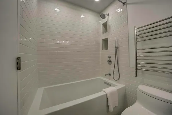 a bathroom with a bathtub and a shower