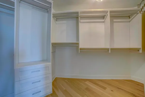 a view of walk in closet with empty racks
