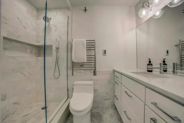 a bathroom with a toilet sink and shower