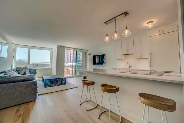 a kitchen with stainless steel appliances granite countertop a sink and a refrigerator