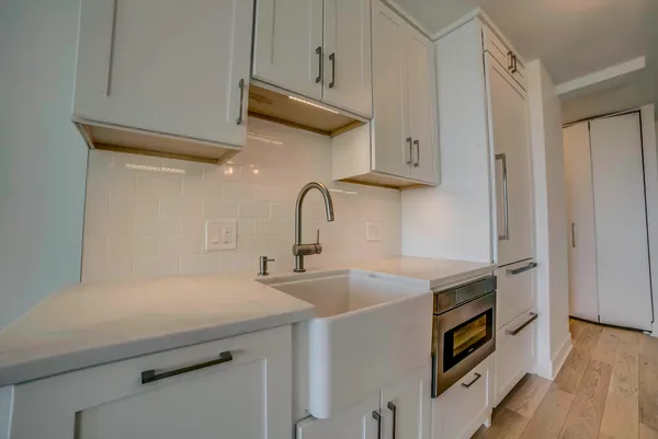 a kitchen with stainless steel appliances a sink and a refrigerator