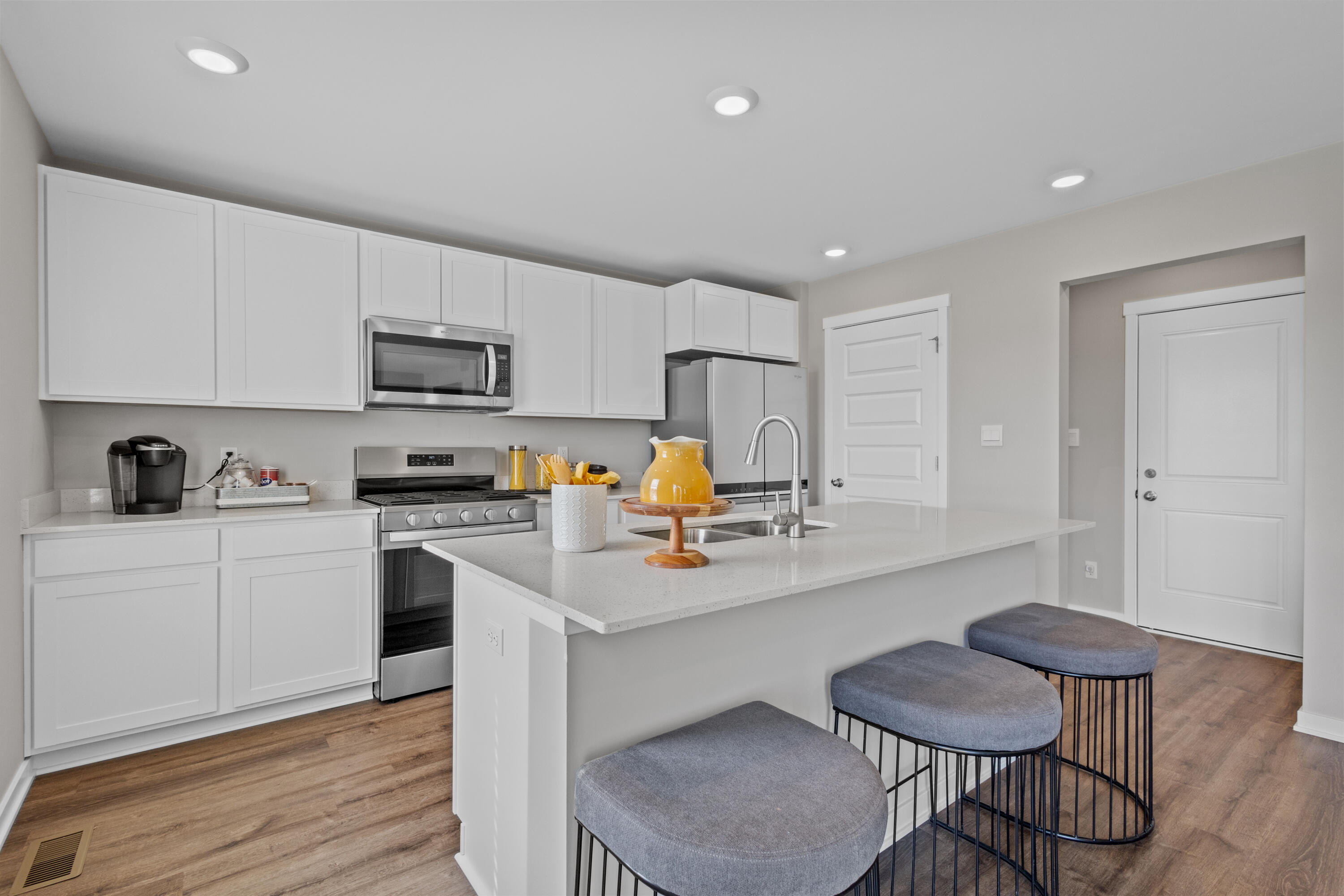 4212 Viceroy Street Portage, IN 46368 - Photo 5 of 35 a kitchen with stainless steel appliances a sink a stove a refrigerator cabinets and chairs