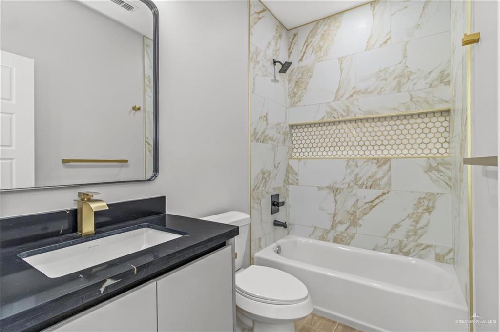 103 Yosemite Drive, Unit 3 Mission, TX 78572 - Photo 6 of 9 a bathroom with a granite countertop sink toilet and shower