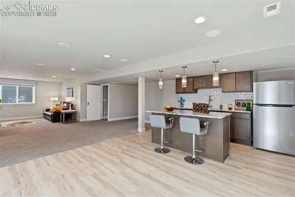 a view of kitchen with furniture and refrigerator